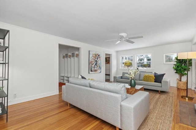 living room featuring light hardwood / wood-style floors and ceiling fan