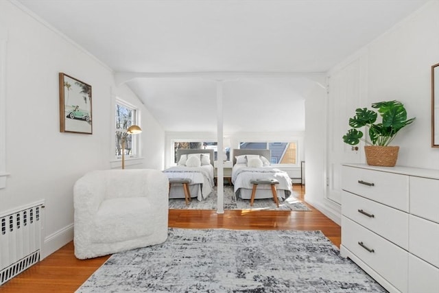 living area with lofted ceiling, radiator, light hardwood / wood-style flooring, and a baseboard radiator