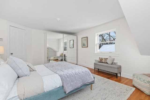 bedroom with hardwood / wood-style flooring