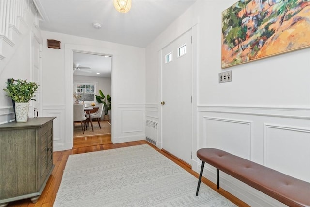 entrance foyer with radiator and light hardwood / wood-style floors