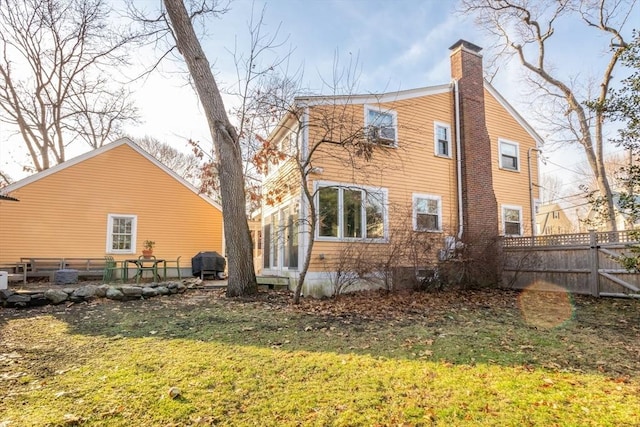 back of house featuring a yard