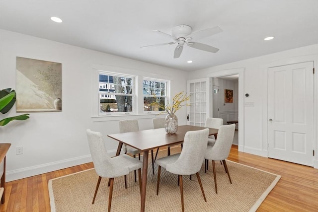 dining room with hardwood / wood-style flooring and ceiling fan