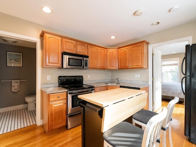 kitchen with sink, light hardwood / wood-style flooring, and stainless steel appliances