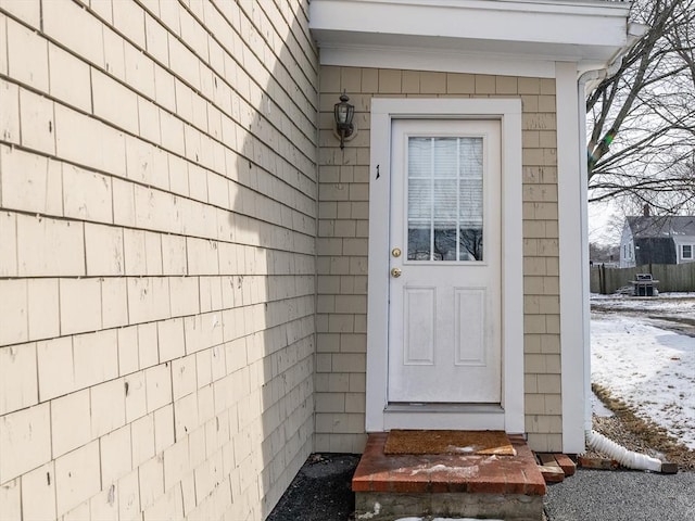 view of snow covered property entrance