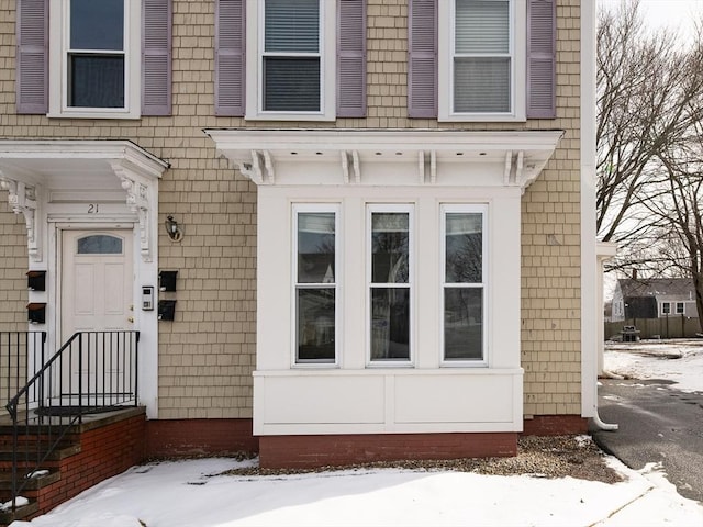 view of snow covered property entrance