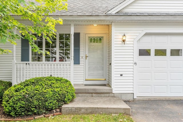 43 Warwick Rd, Gardner, MA 01440 - property entrance featuring a shingled roof and a garage