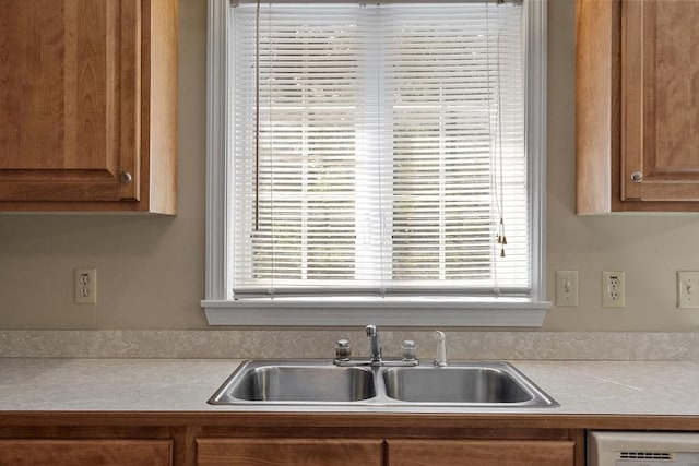 43 Warwick Rd, Gardner, MA 01440 - kitchen with a sink, light countertops, dishwasher, and brown cabinetry