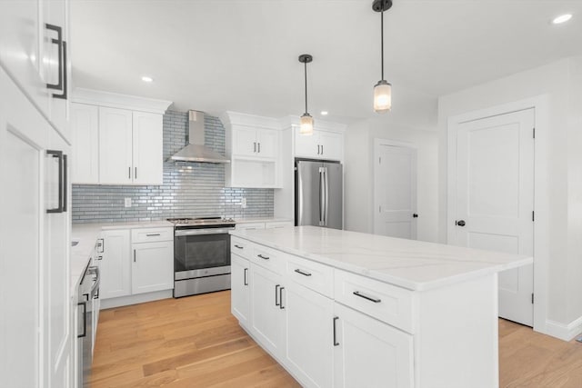 9 Patten Rd, Norton, MA 02766 - kitchen with appliances with stainless steel finishes, wall chimney range hood, backsplash, light wood-style floors, and recessed lighting