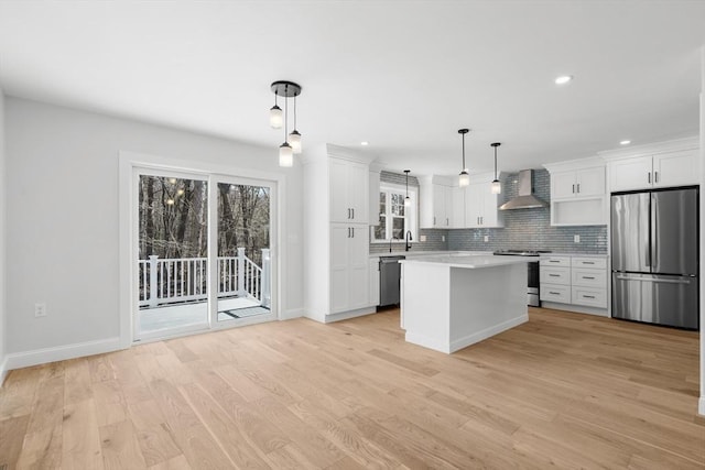 9 Patten Rd, Norton, MA 02766 - kitchen with appliances with stainless steel finishes, wall chimney exhaust hood, light countertops, white cabinetry, and recessed lighting