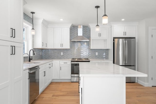 9 Patten Rd, Norton, MA 02766 - kitchen with appliances with stainless steel finishes, wall chimney range hood, decorative backsplash, light wood-style flooring, and white cabinets