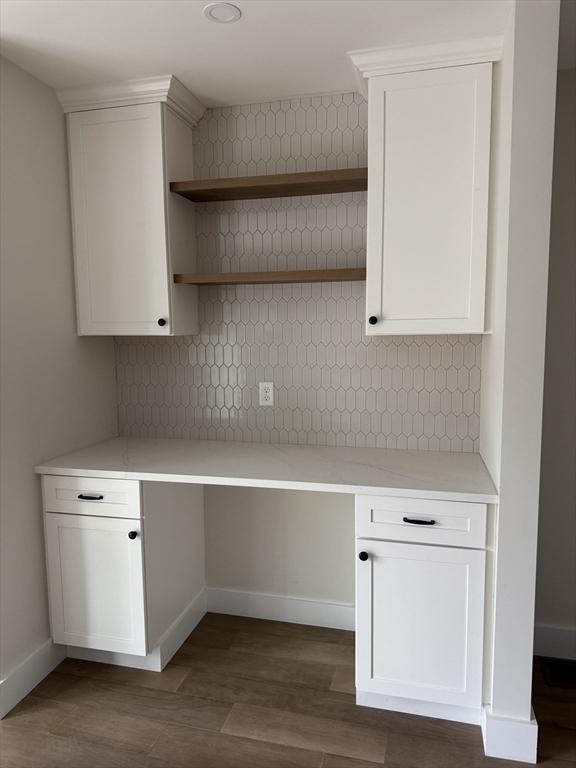 9 Patten Rd, Norton, MA 02766 - kitchen with built in study area, dark wood-style floors, and decorative backsplash