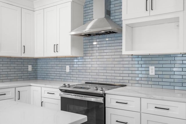 9 Patten Rd, Norton, MA 02766 - kitchen with stainless steel electric range oven, wall chimney range hood, backsplash, and white cabinetry