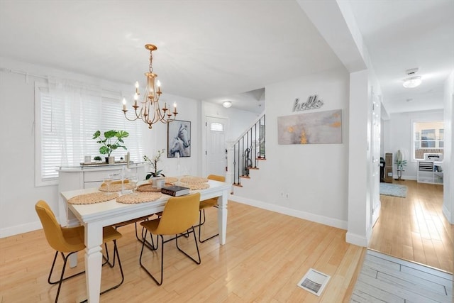 45 Olney Ave, Springfield, MA 01119 - dining space with a chandelier, stairway, and light wood finished floors