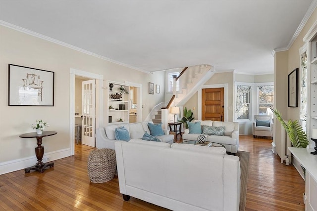 living room with wood-type flooring and ornamental molding