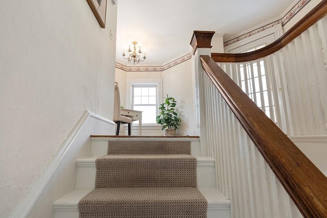 stairs with an inviting chandelier