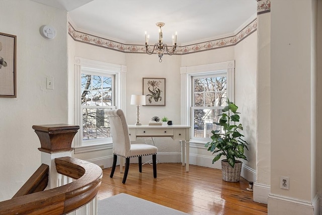 office area with hardwood / wood-style floors and a notable chandelier