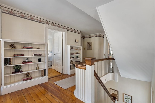 stairway featuring hardwood / wood-style floors and lofted ceiling