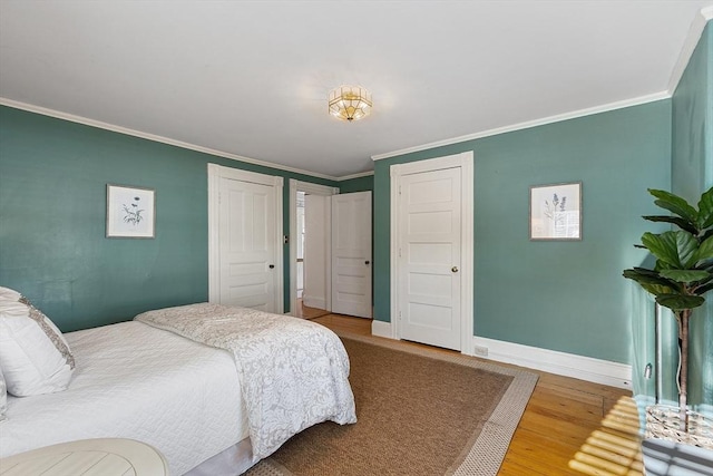 bedroom with hardwood / wood-style flooring and crown molding