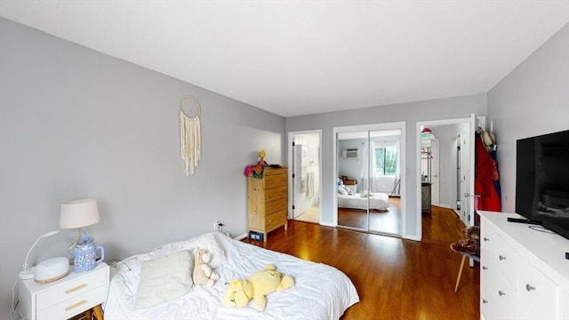 10 Williams St Unit 26, Watertown, MA 02472 - bedroom with wood finished floors and a wall mounted AC