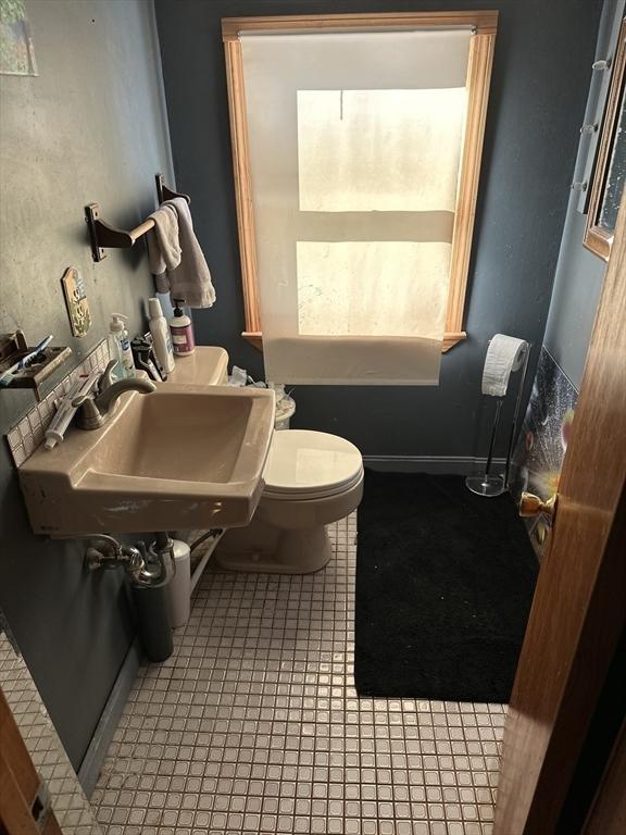 bathroom with tile patterned flooring, sink, and toilet