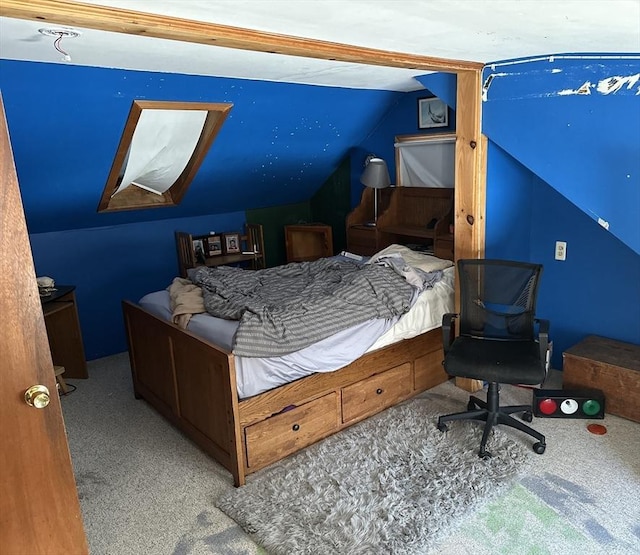 carpeted bedroom with lofted ceiling