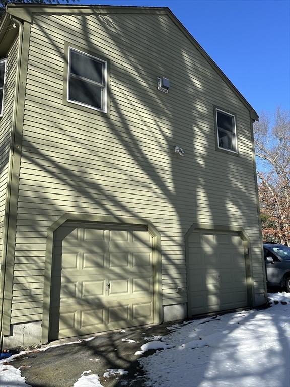 view of snowy exterior with a garage