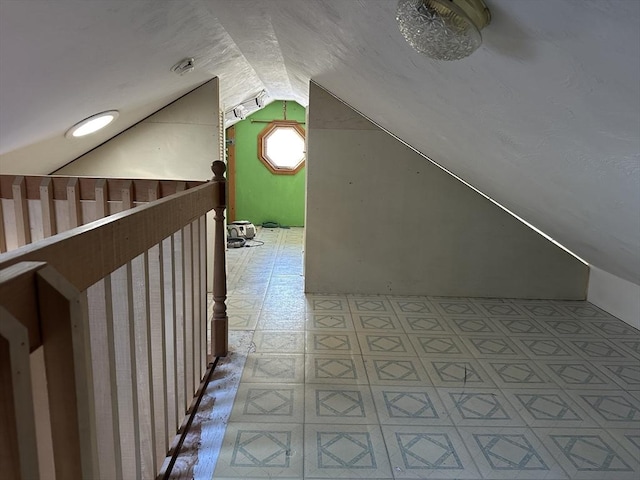 additional living space featuring lofted ceiling