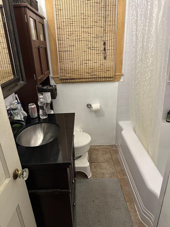 full bathroom with tile patterned flooring, vanity, shower / tub combo with curtain, and toilet