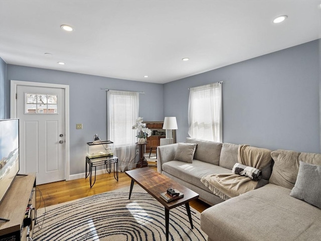 living area featuring plenty of natural light, wood finished floors, and recessed lighting