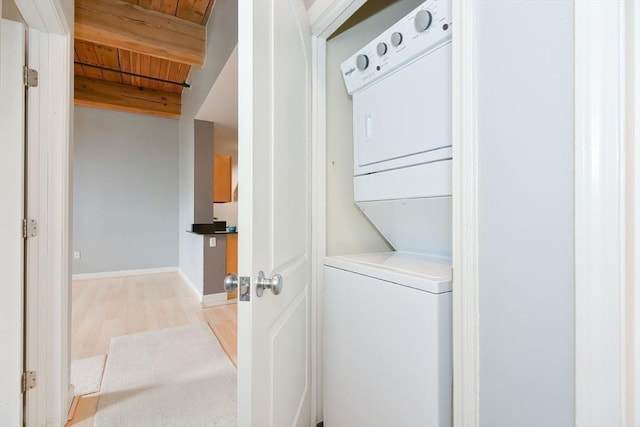 52 Lawrence Dr Unit 312, Lowell, MA 01854 - laundry area featuring stacked washer / drying machine, wood ceiling, and light wood-type flooring