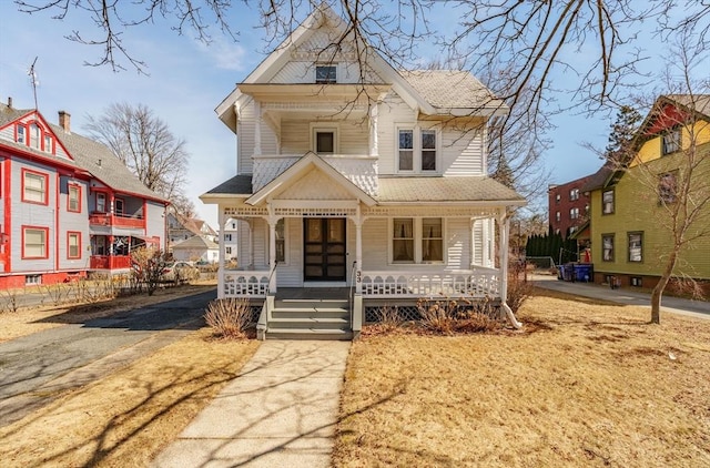 victorian-style house featuring covered porch