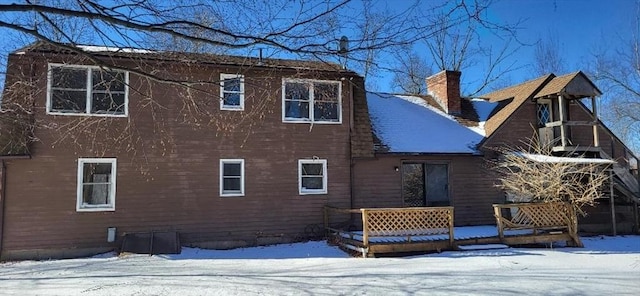 view of snow covered rear of property