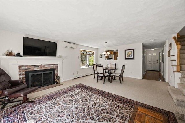 1 Calico Cir Unit 1, Dennis, MA 02639 - carpeted living room with baseboard heating, a brick fireplace, an AC wall unit, baseboards, and stairway