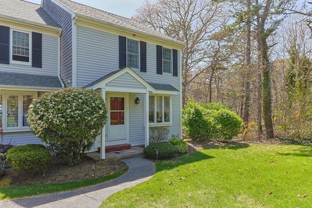 1 Calico Cir Unit 1, Dennis, MA 02639 - view of front of property featuring a shingled roof and a front yard