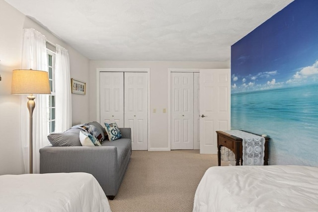 1 Calico Cir Unit 1, Dennis, MA 02639 - bedroom with baseboards, two closets, and light colored carpet