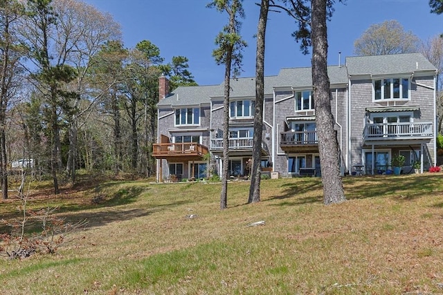1 Calico Cir Unit 1, Dennis, MA 02639 - back of house featuring roof with shingles, a chimney, and a yard