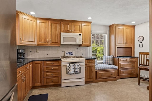 1 Calico Cir Unit 1, Dennis, MA 02639 - kitchen with white appliances, decorative backsplash, recessed lighting, and light carpet
