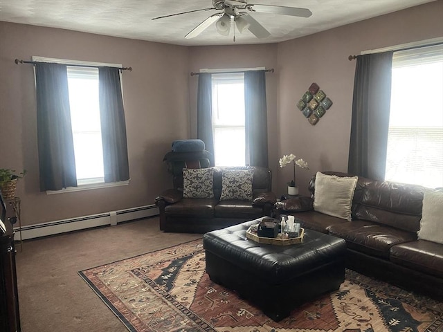 carpeted living room with ceiling fan and a baseboard radiator