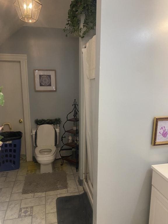 bathroom featuring a stall shower, vanity, and toilet