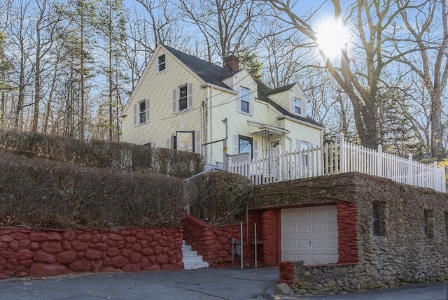 exterior space featuring a balcony and a garage