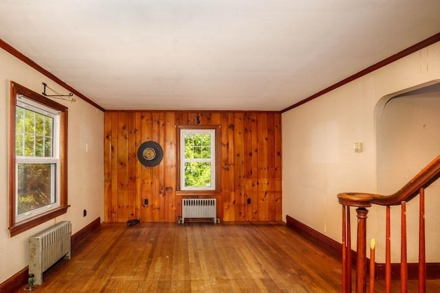 326 Lake Rd, Ashburnham, MA 01430 - spare room featuring radiator, wood finished floors, ornamental molding, baseboards, and wood walls
