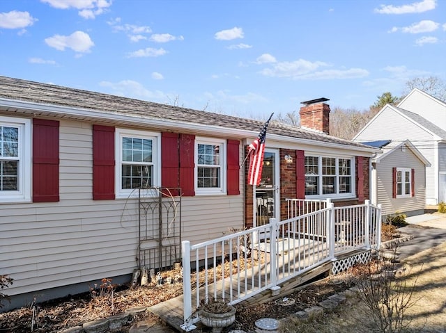 view of front of house featuring a chimney