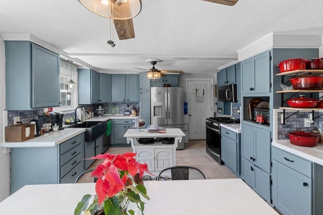 kitchen with a sink, light countertops, decorative backsplash, and stainless steel appliances