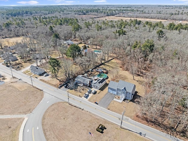 drone / aerial view with a wooded view