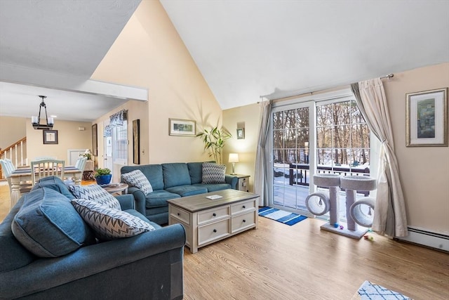 living room with vaulted ceiling and light hardwood / wood-style floors