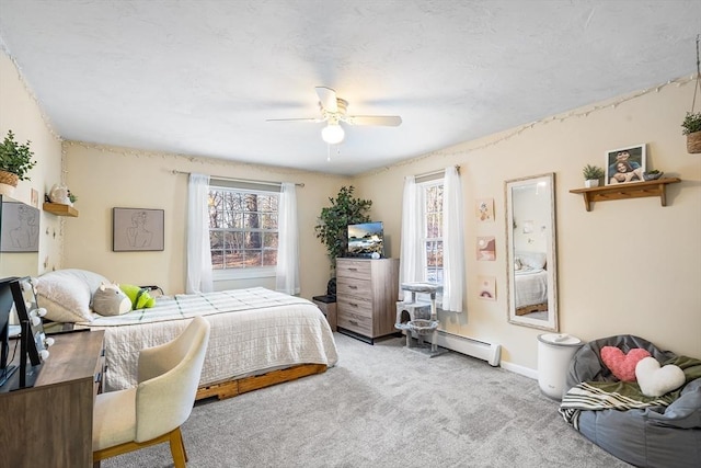 bedroom with baseboard heating, ceiling fan, and carpet