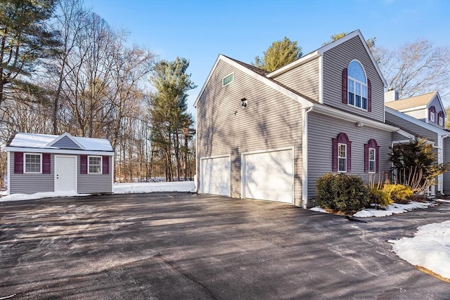 snow covered property featuring a garage