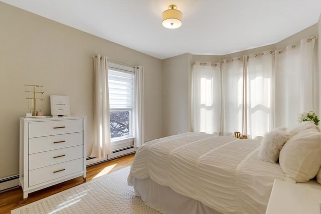 34 Warren St Unit 3, Stoneham, MA 02180 - bedroom with baseboard heating and wood finished floors