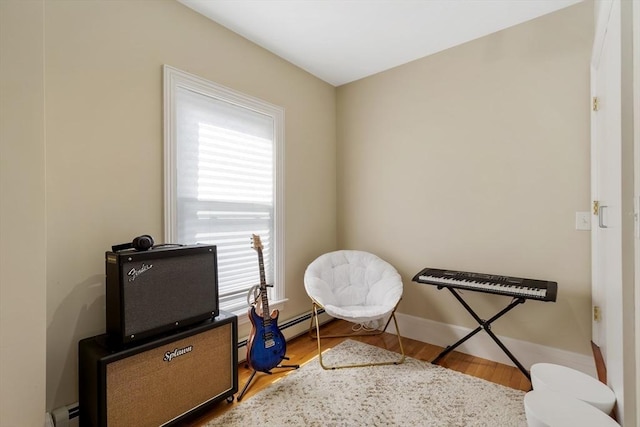 34 Warren St Unit 3, Stoneham, MA 02180 - living area with a baseboard heating unit and wood finished floors