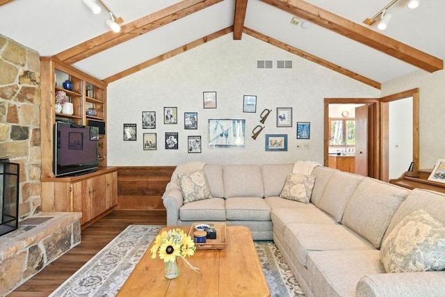 living room featuring rail lighting, visible vents, vaulted ceiling with beams, and dark wood-type flooring